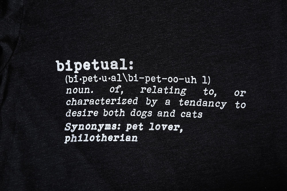 Closeup of t-shirt with a dictionary definition of "bipetual": noun. of, related to, or characterized by a tendency to desire both dogs and cats