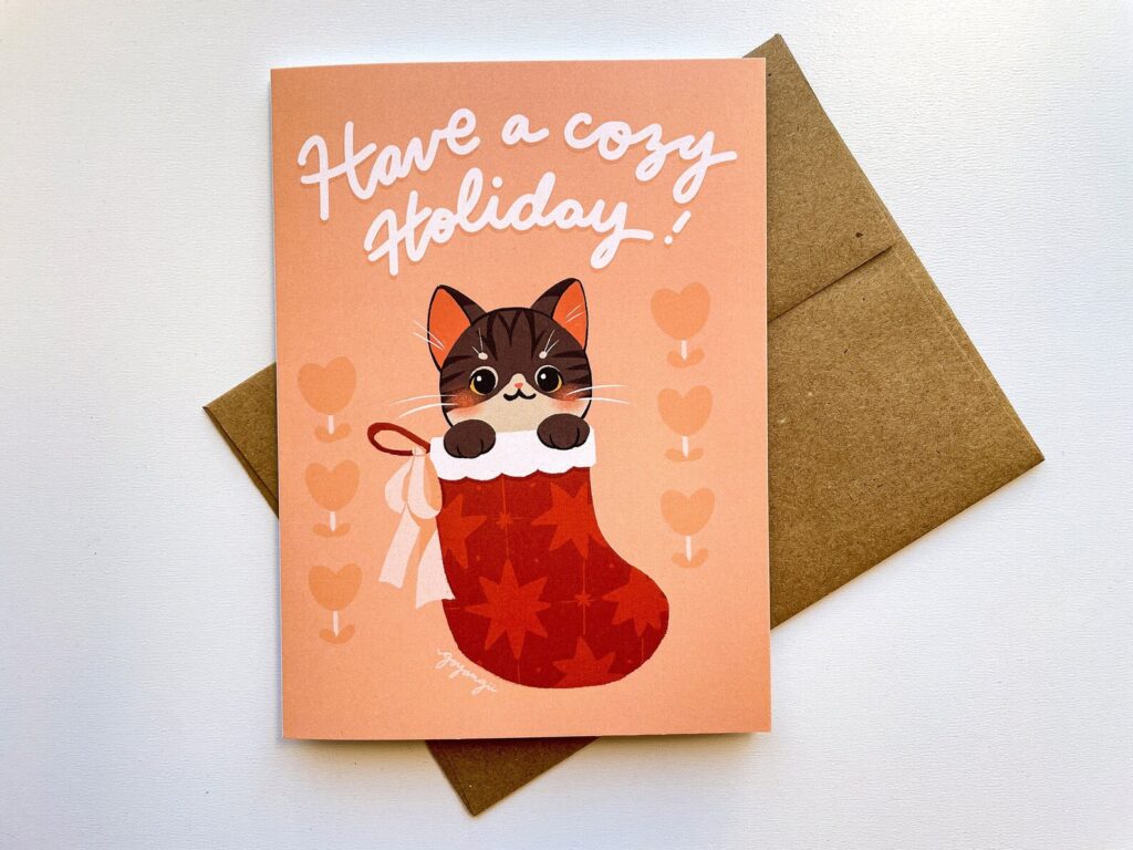 Greeting card with illustration of a cat in a stocking and the caption "Have a Cozy Holiday"