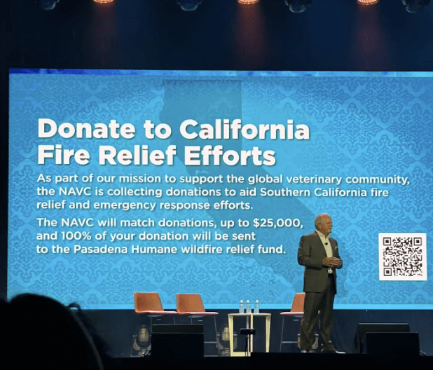 Speaker onstage at VMX 2025 raising awareness around California Fire Relief Efforts